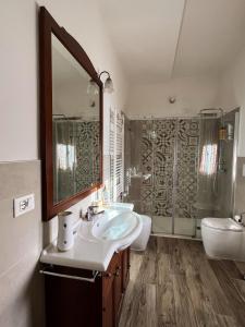 a bathroom with a sink and a mirror and a shower at Casa Bianca Soave in Soave