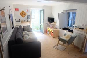 a living room with a couch and a tv at Apto Bakio a pie de playa in Bakio