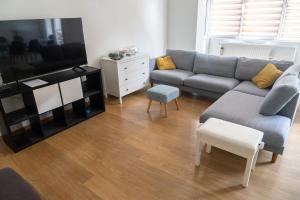 a living room with a couch and a tv at LE PARADIS ATHOIS in Ath