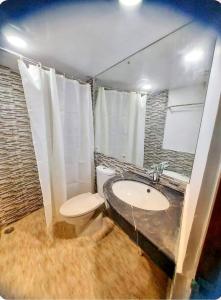 a bathroom with a toilet and a sink at Akbar’s Hotel in Dhaka