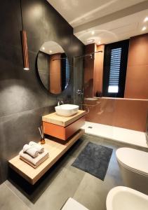 a bathroom with a sink and a mirror at Jasmine Malpensa & Busto center in Busto Arsizio