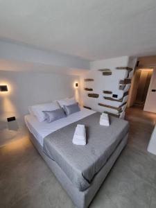 a bedroom with a large bed with two pillows at Màrgaros House Tinos in Triandáros +31 photos
