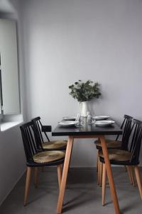 a table with chairs and a vase of flowers on it at Màrgaros House Tinos in Triandáros +31 photos