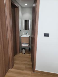 a bathroom with a sink and a mirror at Downtown puntacana luxury suites in Punta Cana