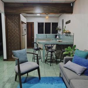 - un salon avec un canapé et une table avec des chaises dans l'établissement Hojas Verdes Rental House Excelente ubicación cerca de Campo Ferial Palmares, à Palmares