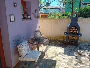 a table and a chair and a stove at ROSE Resort, ROOM 40m2 for 4 guests, with terrace in Ljubljana