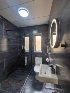 a bathroom with a toilet and a sink and a shower at KORZO SUITES SENGLEA WATERFRONT in Senglea +45 photos