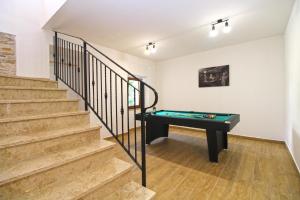 a room with a ping pong table and stairs at Ferienhaus mit Privatpool für 6 Personen ca 125 qm in Ližnjan, Istrien Südküste von Istrien in Ližnjan