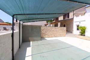 awning over a patio of a house at Ferienhaus mit Privatpool für 6 Personen ca 125 qm in Ližnjan, Istrien Südküste von Istrien in Ližnjan