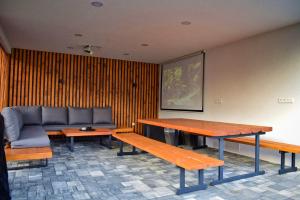 a room with benches and a couch and a table at Chalupa Martinček in Terchová