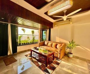 a living room with a couch and a table at sea view apartment in Juhu in Mumbai