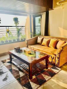 a living room with a couch and a coffee table at sea view apartment in Juhu in Mumbai