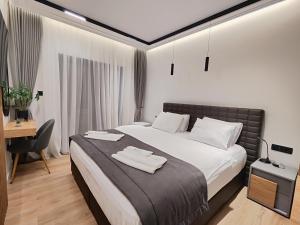 a bedroom with a bed and a desk and a chair at AMD Premium rooms Budva in Budva