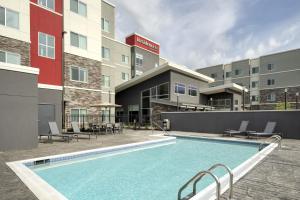 a swimming pool in front of a building at Residence Inn by Marriott Jonesboro in Jonesboro