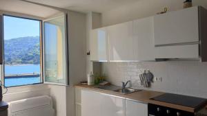 a kitchen with a sink and a window at Cà dela Fanteleta in Portovenere