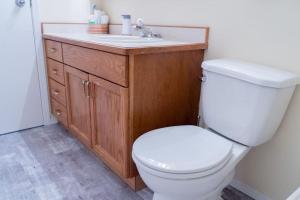 a bathroom with a white toilet and a sink at Home Away from Home - Guest Suite 1 in Red Deer +10 photos