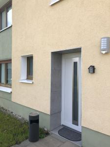 a white door on the side of a building at Ferienwohnung Zur Wildkatze in Hallenberg