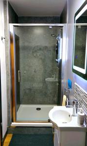 a bathroom with a shower and a sink at Four Winds Holiday Let in Nairn