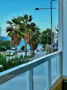 a window with a view of a street and palm trees at Apartamento Vacacional Sol y Mar in Manilva