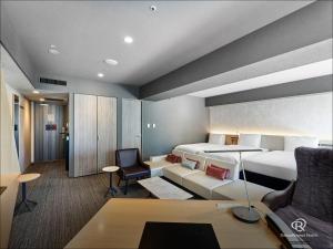 a hotel room with a bed and a desk at Daiwa Roynet Hotel Nishi-Shinjuku PREMIER in Tokyo