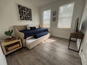 a living room with a bed and a couch at Brickell + Wynwood Wonderland: Spacious 6BR Home in Miami +37 photos