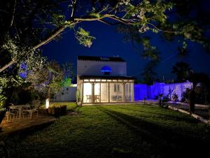 a house with a lit up yard at night at Cortijito dúplex Mangueta in El Palmar