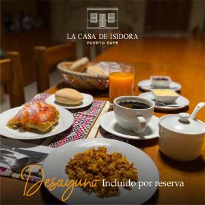 a table with plates of food and a cup of coffee at La Casa de Isidora in Pan de Azúcar +9 photos