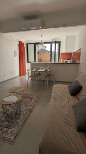 a living room with a couch and a table at Appartement intra-muros in Aigues-Mortes
