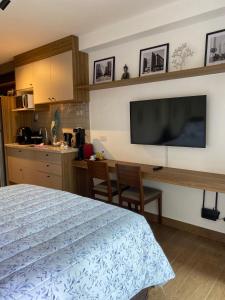 a bedroom with a bed and a flat screen tv at For You Moema 302 Studio da Andrea in São Paulo