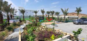 a car parked in a parking lot with a playground at شاليه لحظات in Āsam