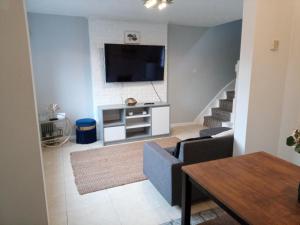 a living room with a flat screen tv on a wall at Beautiful 2-Bed House in Bolton with free parking in Bolton
