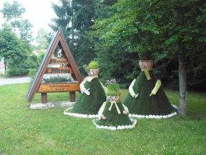 two women in dresses sitting in the grass at Ferienwohnung für 2 Personen ca 31 qm in Altenau, Harz Oberharz - a81344 in Altenau