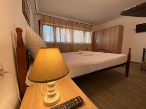 a bedroom with a bed and a lamp on a table at Penelope's apartment Ι in Potamiá