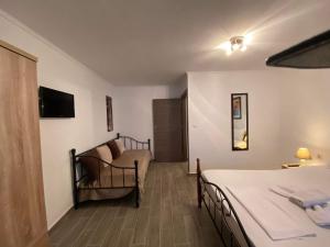 a room with two beds and a chair in it at Penelope's apartment Ι in Potamiá