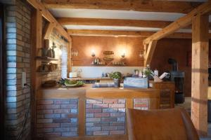 a kitchen with wooden counters and a brick wall at Sonnenhügel in Neu Karin