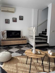 a living room with a flat screen tv and a couch at Apartamento Dúplex Cala de Mijas in La Cala de Mijas