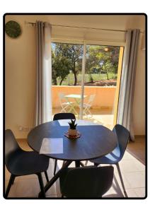 a table and chairs in a room with a window at Appartement Roussillon in Roussillon