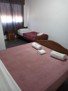 1 dormitorio con 2 camas y toallas en la cama en La Nueva Estancia en Santa Rosa