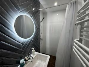 a bathroom with a mirror and a sink at Villa Marbela in Ustka +26 photos