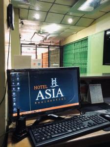 a computer monitor sitting on top of a desk at Hotel Asia in Cox's Bazar