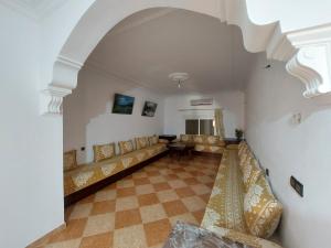 een woonkamer met een bank en een tafel bij Vintage Palace in Ksar es Sghir