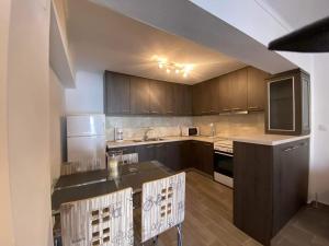 a kitchen with wooden cabinets and a counter top at Penelope's apartment Ι in Potamiá