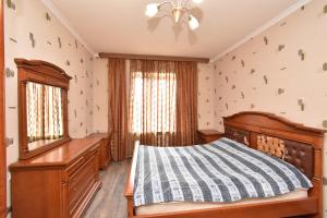 a bedroom with a bed and a desk at Apartment in Zakyan 4 street in Yerevan