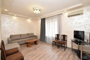 a living room with a couch and a television at Apartment in Zakyan 4 street in Yerevan