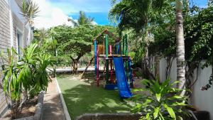a playground in the backyard of a house at ISLA HOLIDAY HOME in Anse Royale
