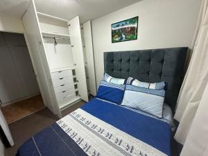 リマにある595 Departamento en Chorrillosのベッドルーム(青いベッド1台、クローゼット付)