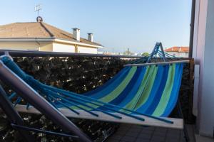 a blue and green hammock on a balcony at Casa Gozza in Verzuolo