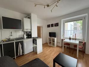 a living room with a kitchen and a dining room at 32m2 - gemütliche Wohnung in zentraler Lage in Hagen