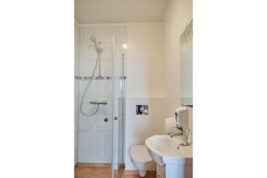 a bathroom with a shower and a toilet and a sink at H&oacute;tel Laugarvatn in Laugarvatn