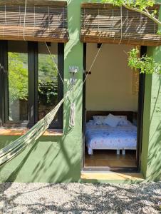 a bed in a house with a hammock in it at Cal Gat in Les Planes d'Hostoles